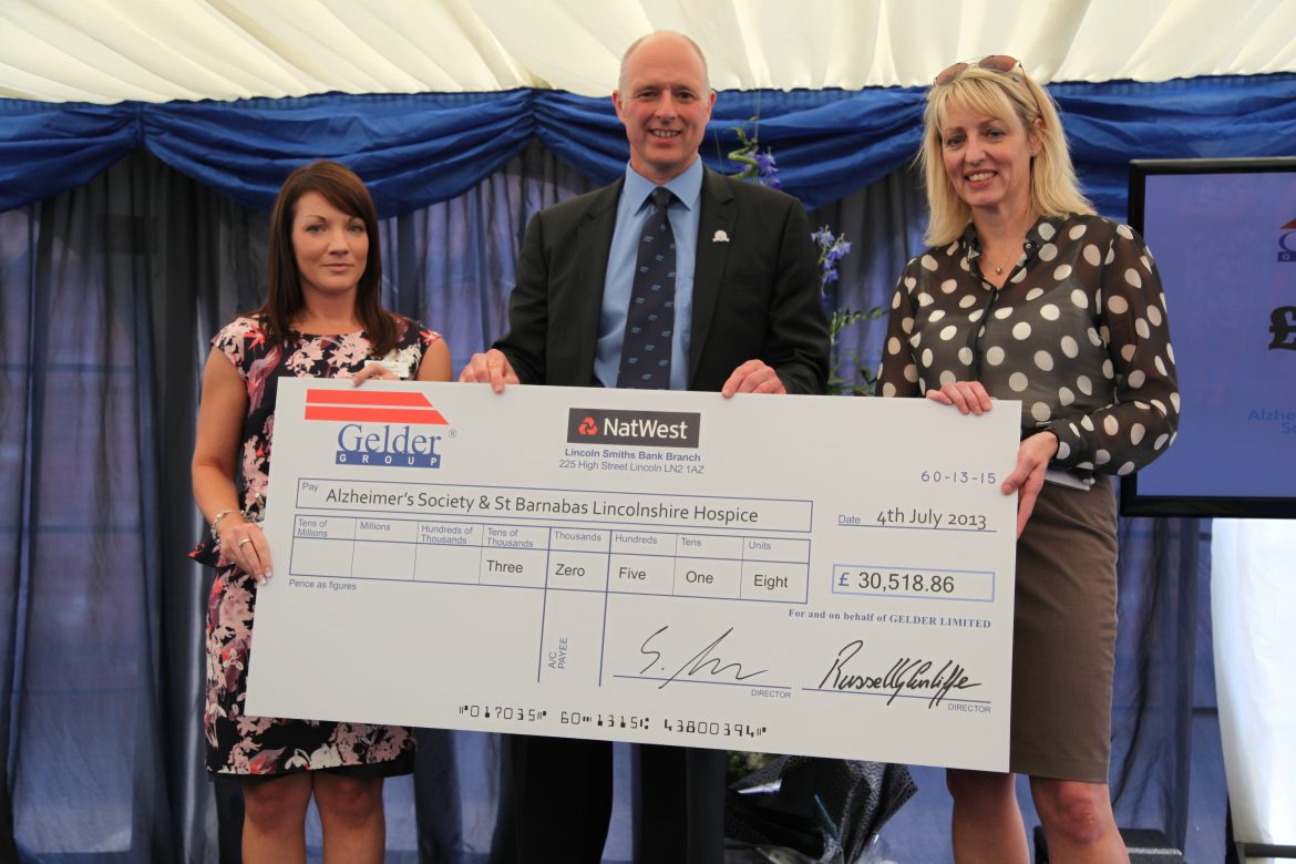 Steve Gelder presenting a cheque to the Alzheimer’s Society and St Barnabas charities.